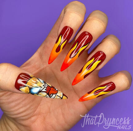 extra long stiletto nails inspired by Sanrio Character Aggretsuko. Shes painted on the thumb screaming while the other nails have flames.